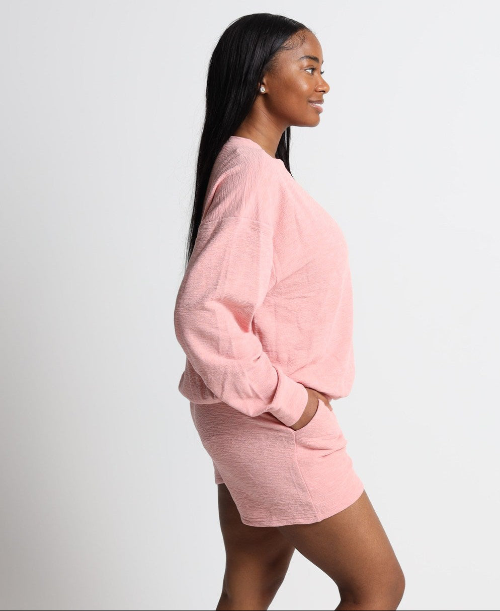 Woman wearing a pink outfit on a white background